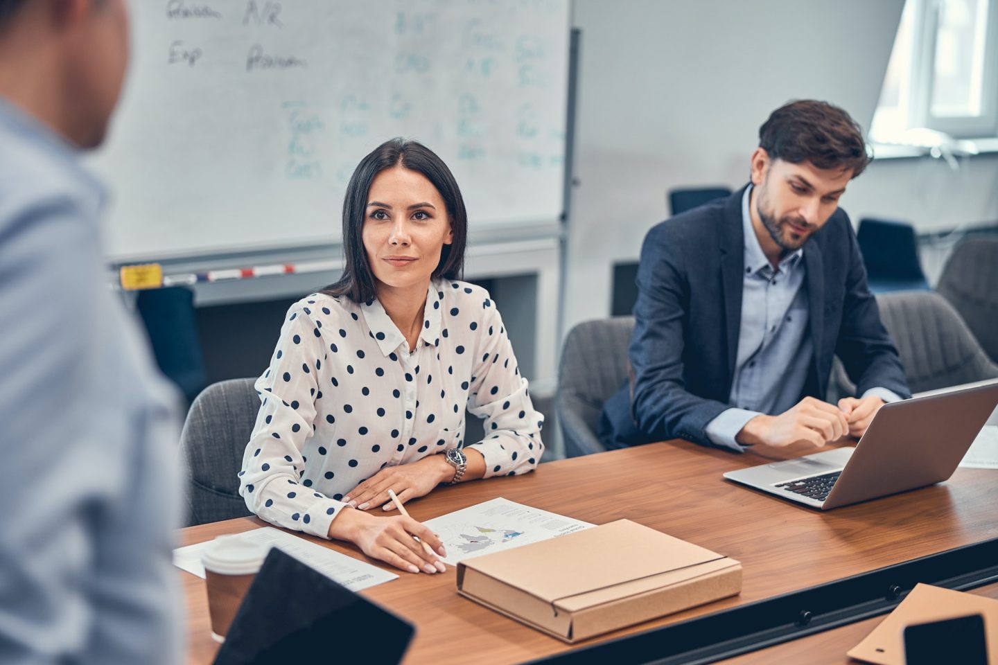 Colleagues working in office discussing developing new industry in business e1699493793229